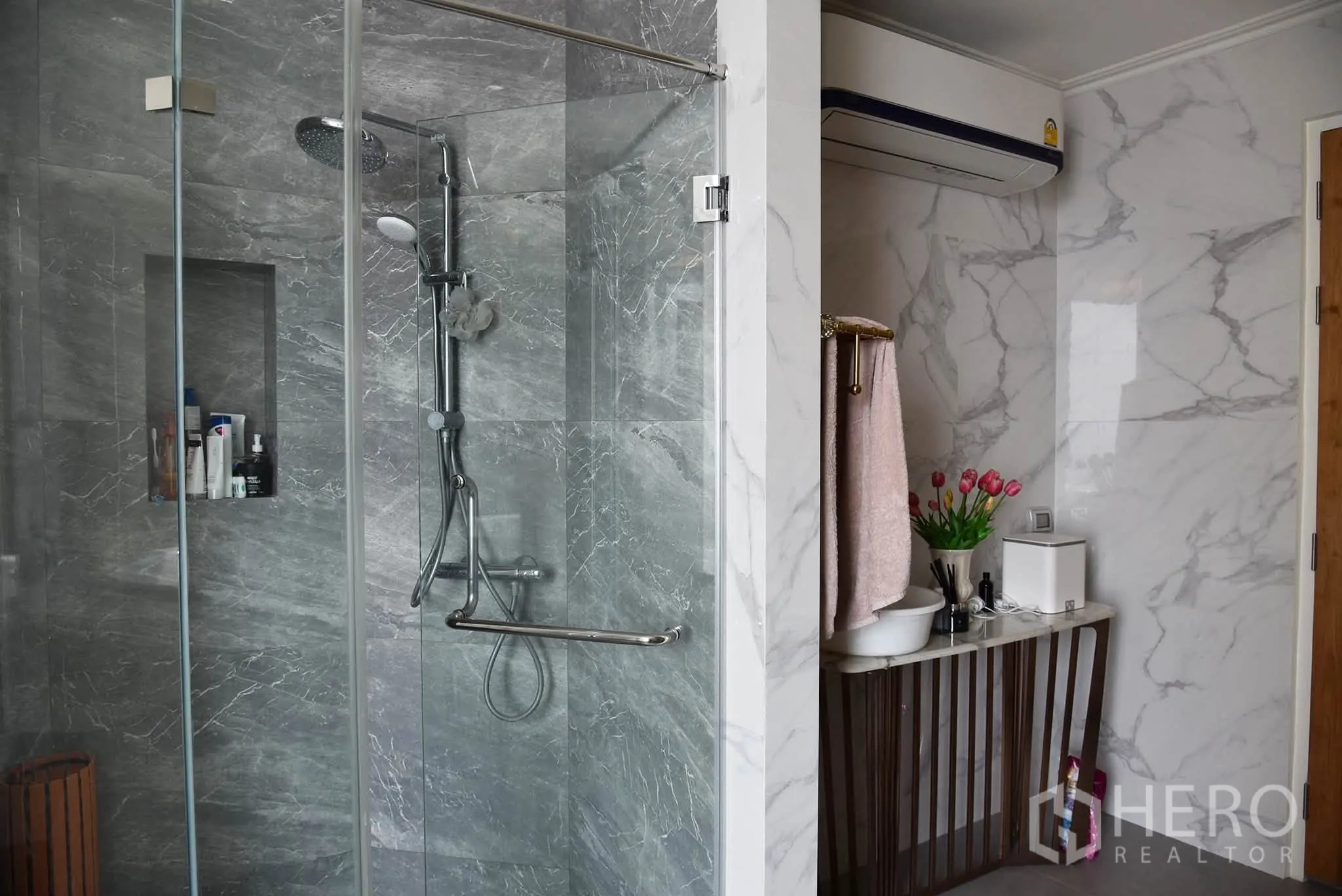 Condominium for sale in Khlong San, Bangkok - Bathroom with a glass-enclosed rain shower and marble finishes.