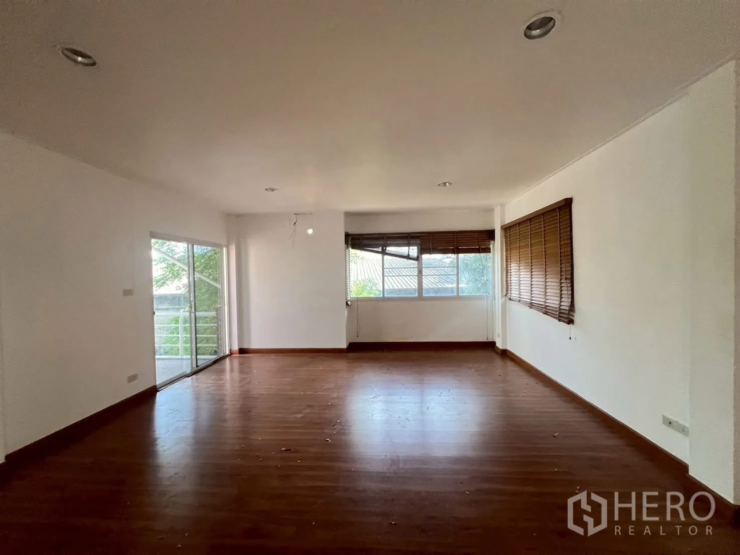Detached House for rent in Watthana, Bangkok - Large upstairs room with wood flooring and windows on two sides.