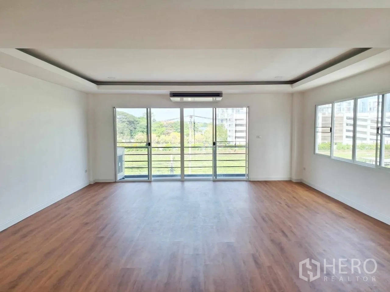 Home Office for sale in Bueng Kum, Bangkok - Upper-floor office with balcony doors and park views across the canal.