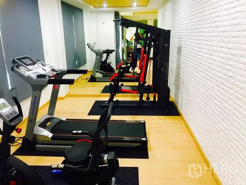 Home Office for rent or sale in Pak Kret, Nonthaburi - Private home gym with treadmill, weight machines and a mirrored wall.
