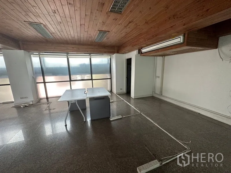 Office Space for rent - Open-plan office with wall of windows, wooden ceiling, polished flooring and floor cable trunking.