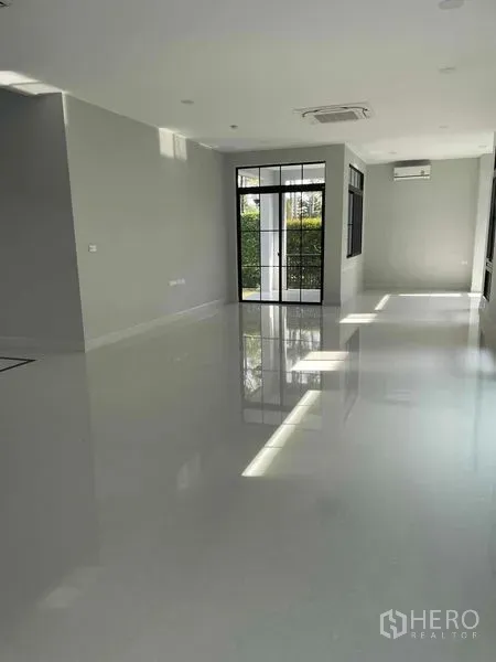 Detached House for sale in Saphan Sung, Bangkok - Sunlit open‑plan living and dining area with glossy floors and large windows.