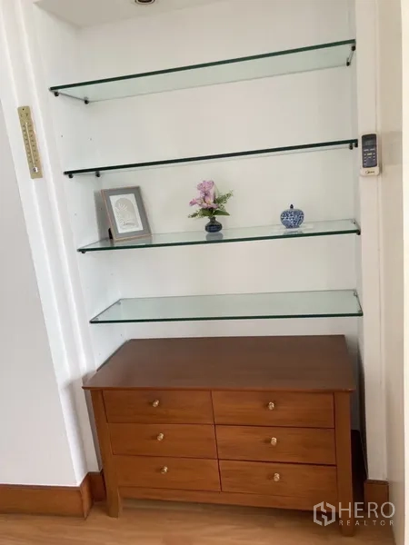 Condominium for rent in Yan Nawa, Bangkok - Built-in glass display shelves with wooden cabinet storage.