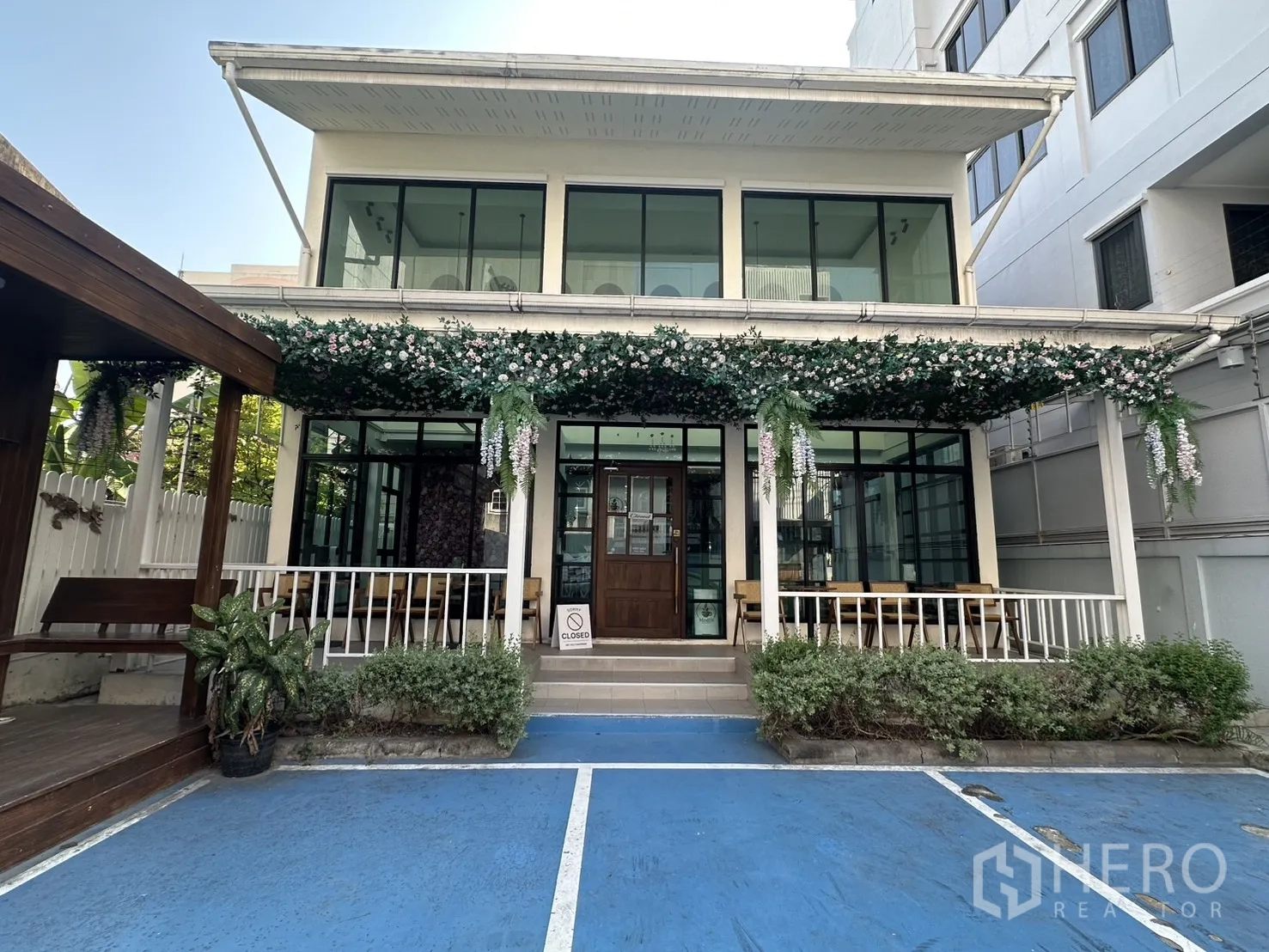 Retail Space for rent in Watthana, Bangkok - Two-storey retail building on Sukhumvit with glass facade, vine-covered canopy, porch seating and on-site customer parking near BTS Ekkamai.