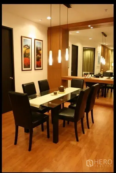 คอนโด ให้เช่าหรือขายในKhlong Toei, Bangkok - มุมทานอาหารโต๊ะหกที่นั่ง โคมไฟห้อย และผนังกระจกเงาบนพื้นไม้โทนอุ่น