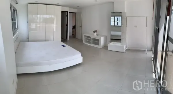 公寓 出租在Sathon, Bangkok - 超大主卧，衣柜、白色家具与宽幅窗户。