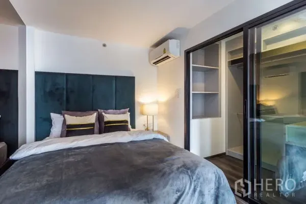 Condominium for rent or sale - Bedroom corner with air conditioner and sliding glass door to a walk-in closet.