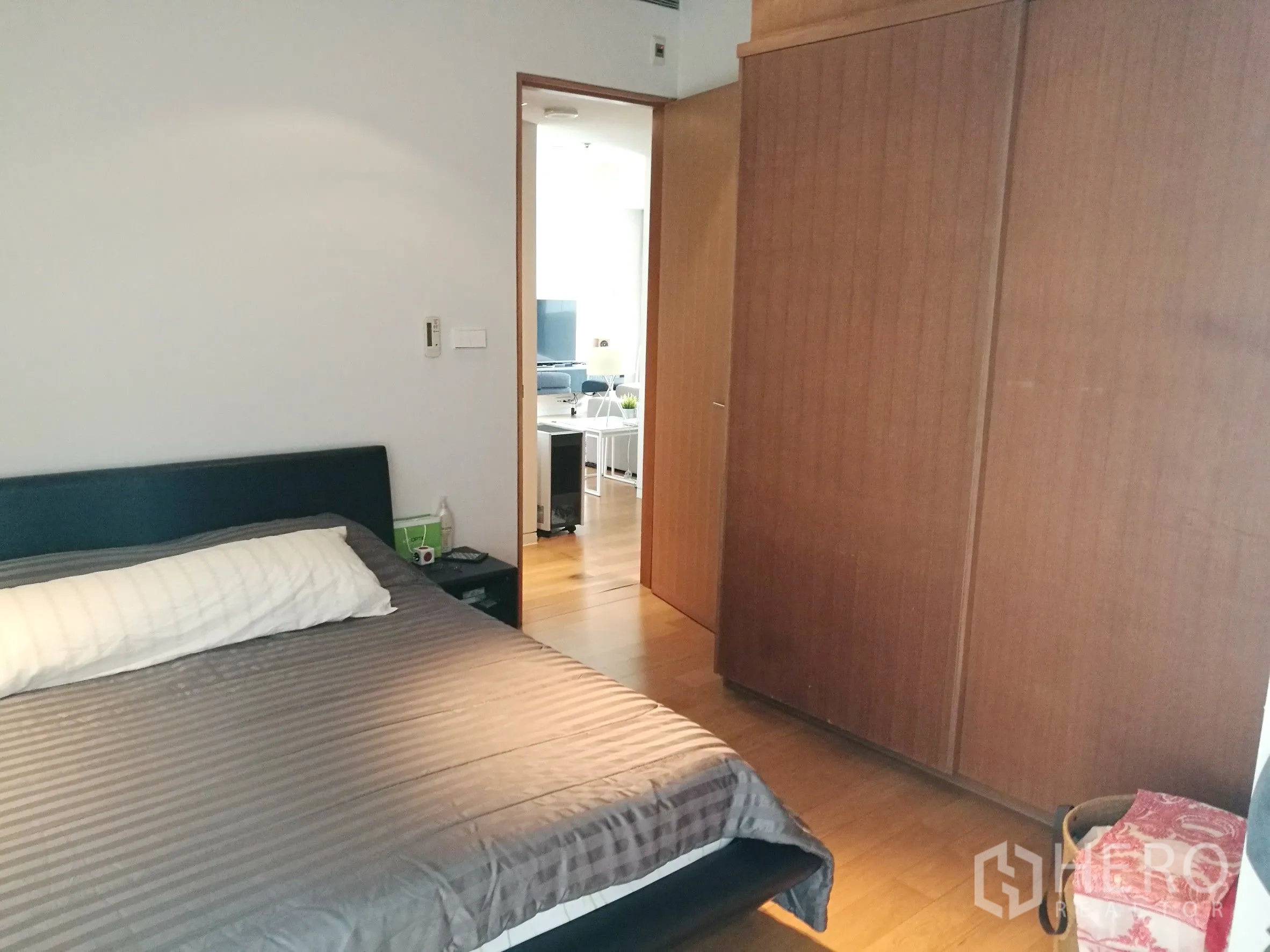 Condominium for rent or sale in Sathon, Bangkok - Master bedroom with double bed, large built-in wardrobe and timber floors.
