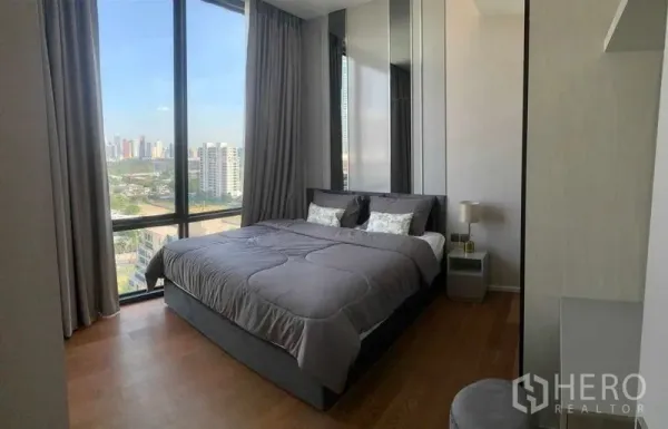 คอนโด ให้เช่าในPathum Wan, Bangkok - ห้องนอนสว่างในคอนโดปทุมวันให้เช่า หน้าต่างบานใหญ่เห็นวิวสกายไลน์และพื้นไม้