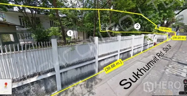 Land for sale - Street view of a long white fence and greenery along the plot, with boundary dimensions marked.