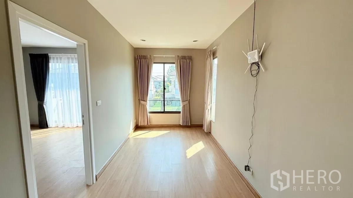 独立式住宅 出租或出售在Bang Phli, Samut Prakan - 楼上多功能房，三面窗户采光充沛，配米色窗帘。