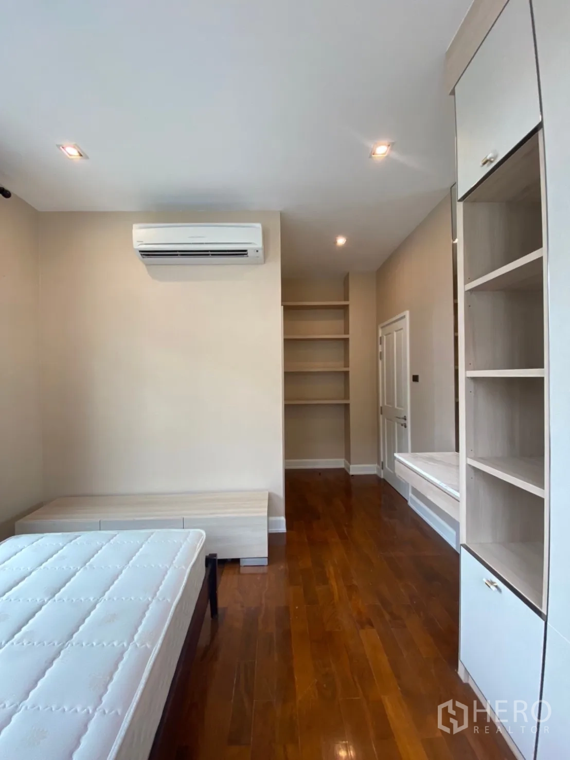 Detached House for rent in Bang Phli, Samut Prakan - Bedroom with air conditioner, built-in storage and single bed frame on wood flooring.
