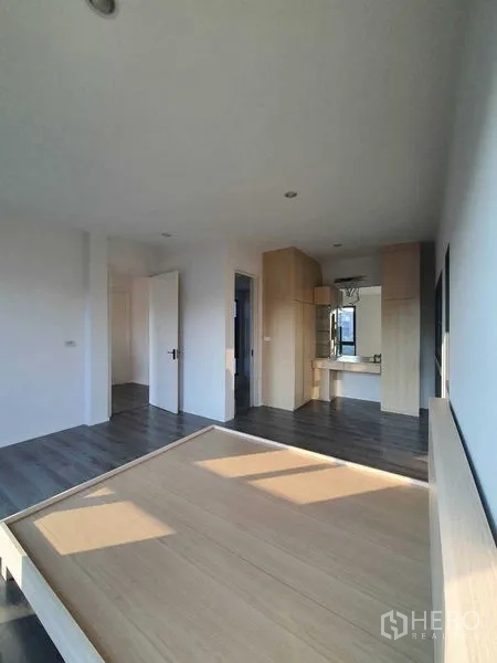 Detached House for sale in Prawet, Bangkok - Bedroom with built-in vanity and light wood accents.