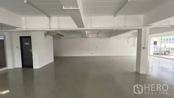 Office Space for rent in Khlong Toei, Bangkok - Spacious open-plan ground floor office with polished flooring and air-conditioning units.