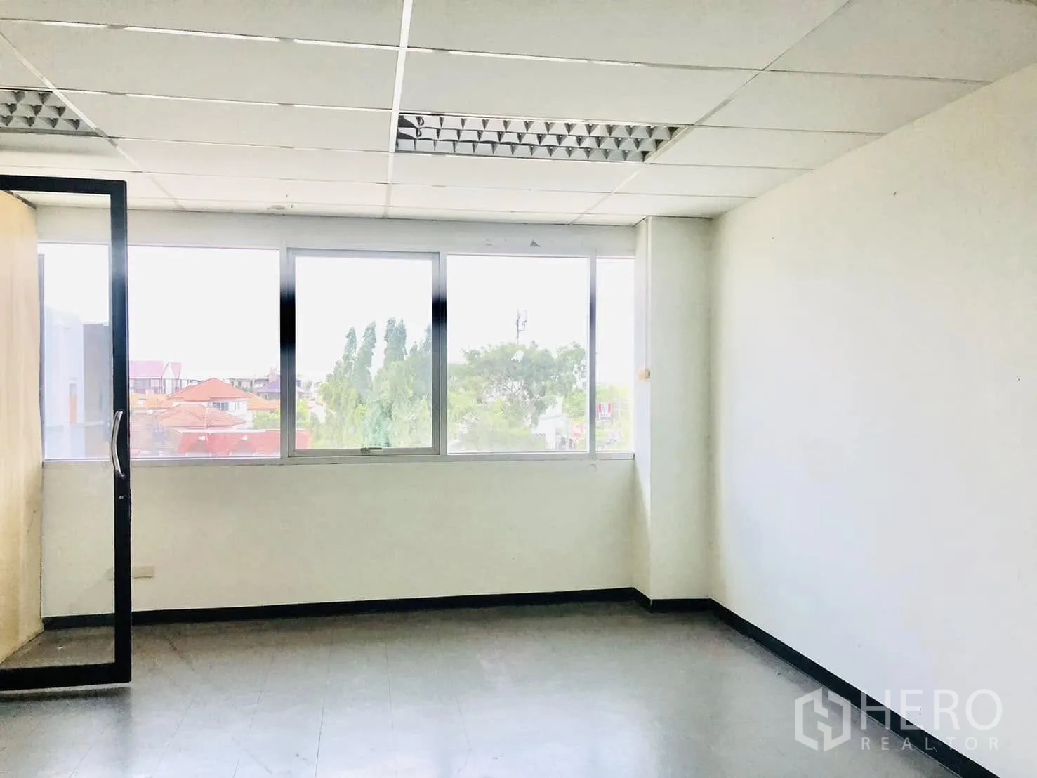 Office Space for rent in Lat Phrao, Bangkok - Bright office room with three-panel window and an open glass door.