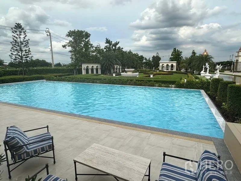 Detached House for sale in Bang Khen, Bangkok - Estate swimming pool overlooking manicured gardens and classical sculptures.