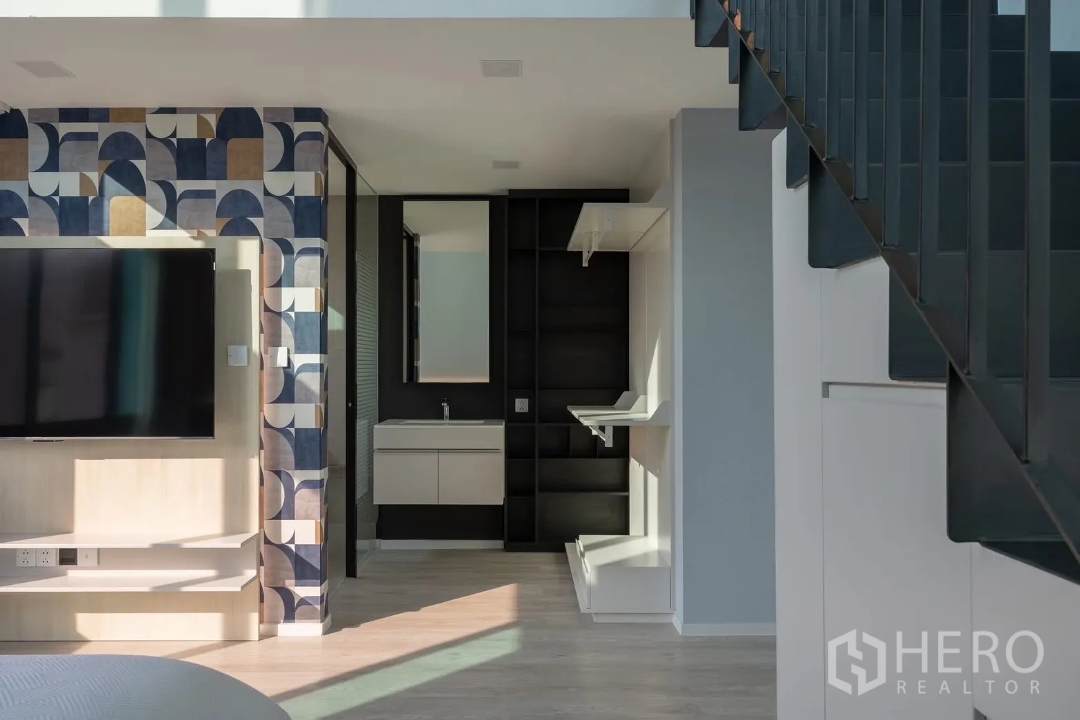 Detached House for rent in Saphan Sung, Bangkok - Upper-floor landing with patterned feature wall, vanity, and staircase view.