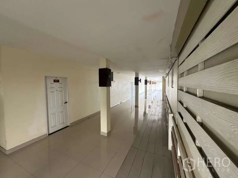 Home Office for rent in Chatuchak, Bangkok - Ground-floor covered walkway with room doors and slatted wall.