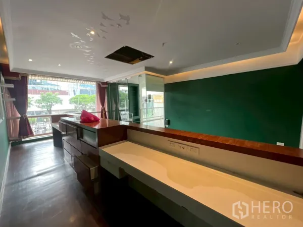 Office Space for rent in Watthana, Bangkok - Front counter workspace facing a street-view window, green walls and glass door entry.
