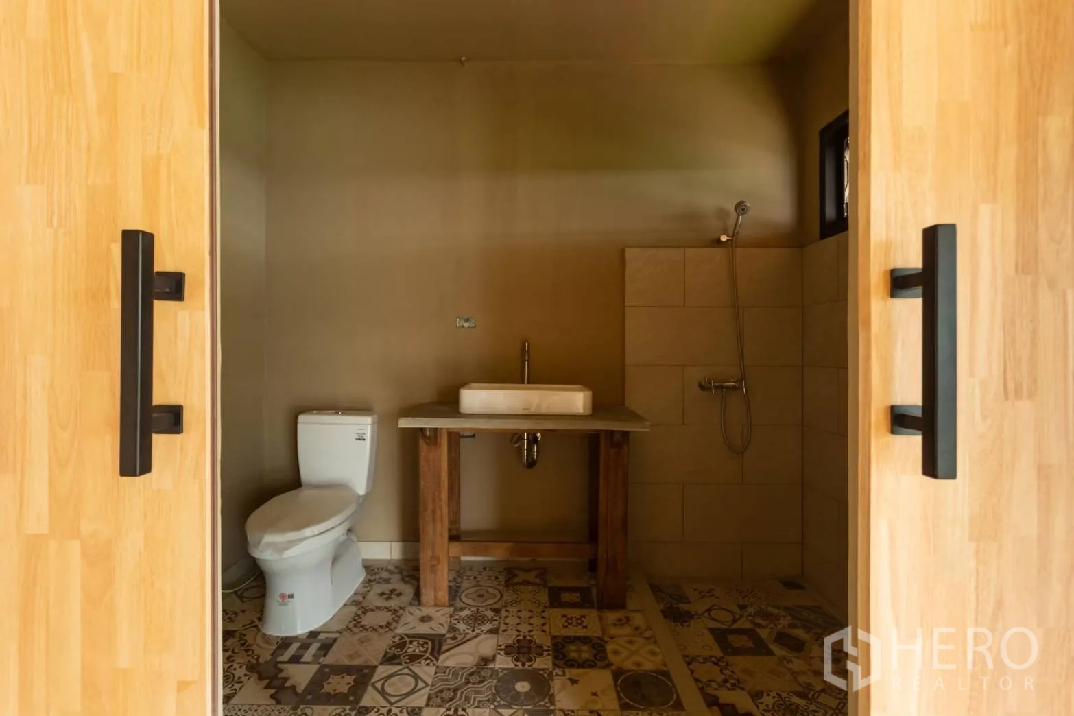 Home Office for rent in Watthana, Bangkok - Modern bathroom with patterned tile floor, walk‑in shower, vanity and toilet.