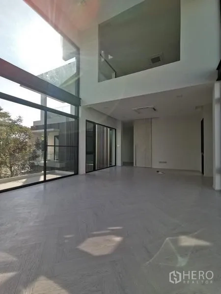 Detached House for rent or sale in Saphan Sung, Bangkok - Double-height living room with full-height glass walls flooding the space with natural light.