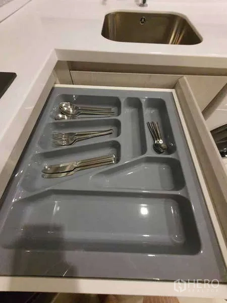 Condominium for rent - Kitchen drawer organized with cutlery next to the sink.
