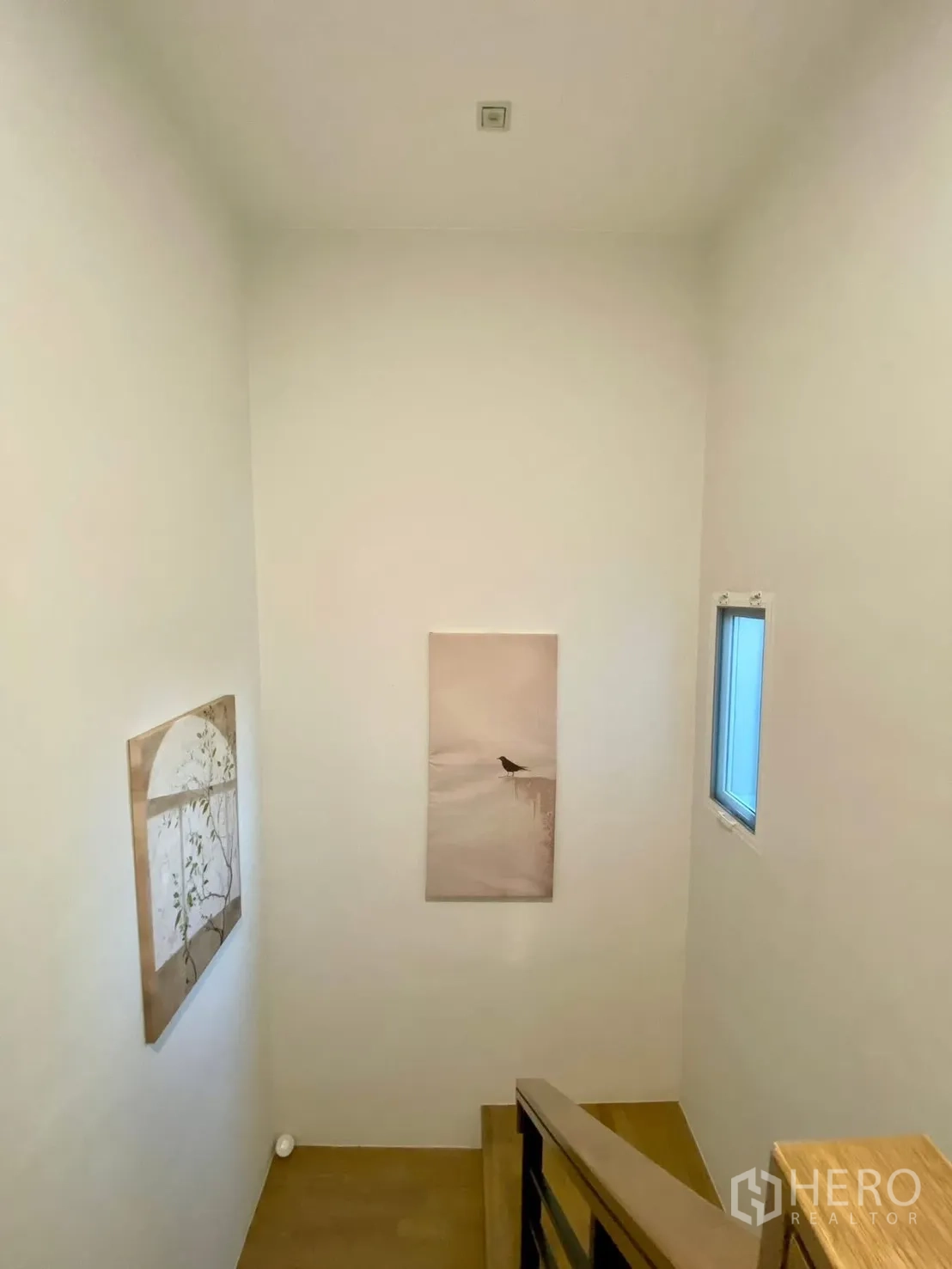 Semi-detached House for rent in Bang Phli, Samut Prakan - Stairwell with high ceiling, small window and minimalist artwork.