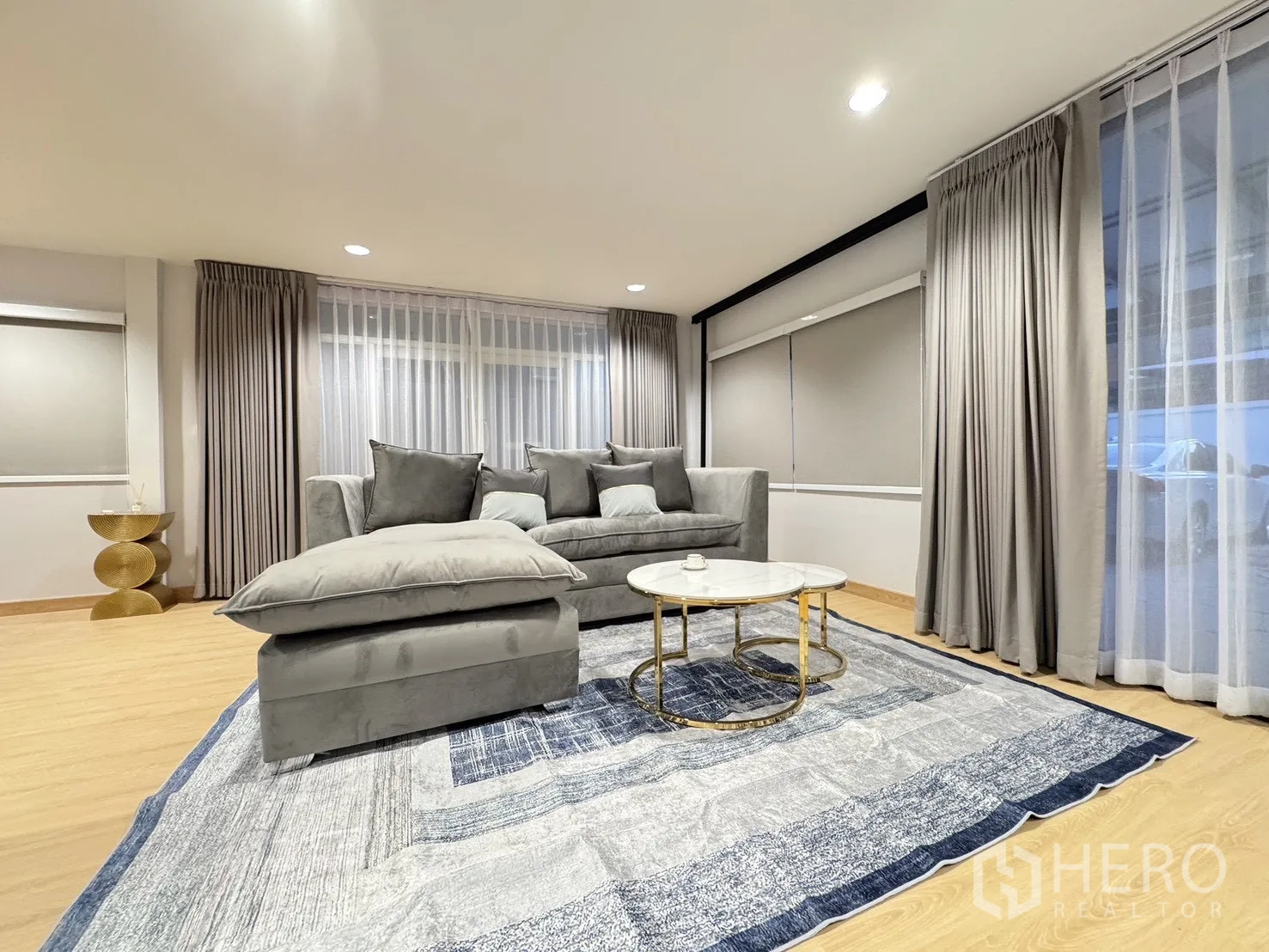 Detached House for rent - Spacious lounge with sectional sofa, layered curtains and floating coffee tables.