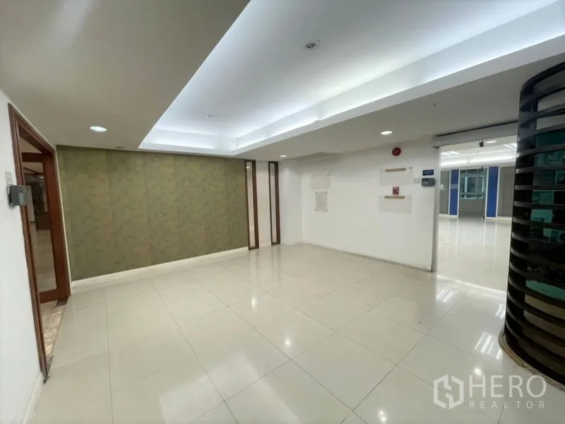 Office Space for rent in Chatuchak, Bangkok - Reception nook with cove lighting, tiled floors, and a green texture accent wall.