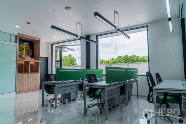 Warehouse for sale in Bang Khen, Bangkok - Bright open‑plan office with marble floors, large windows and workstation desks.