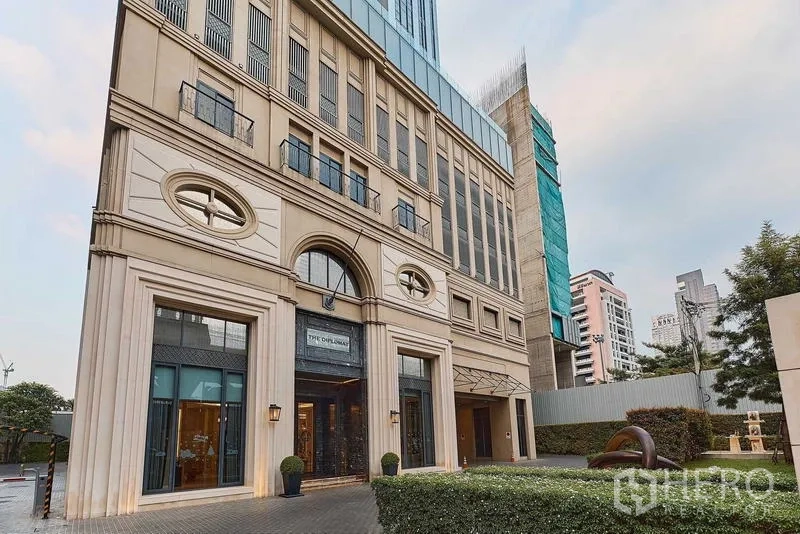 Condominium for sale in Bang Rak, Bangkok - Elegant condominium entrance with grand arched facade and landscaped frontage.
