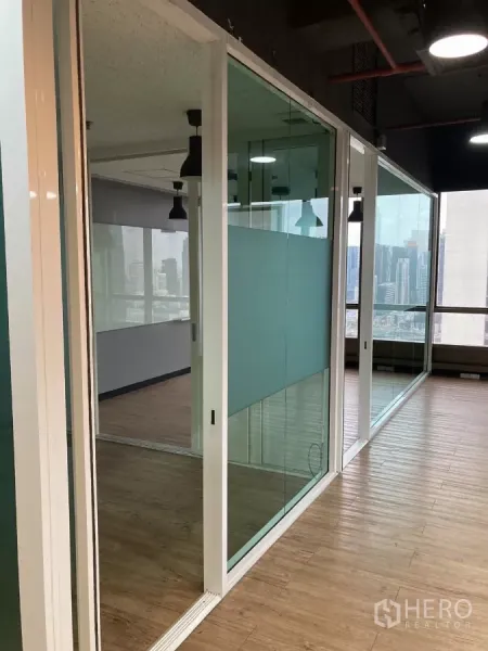 Office Space for rent in Watthana, Bangkok - Row of glass meeting rooms with city views and timber flooring in a Watthana office.