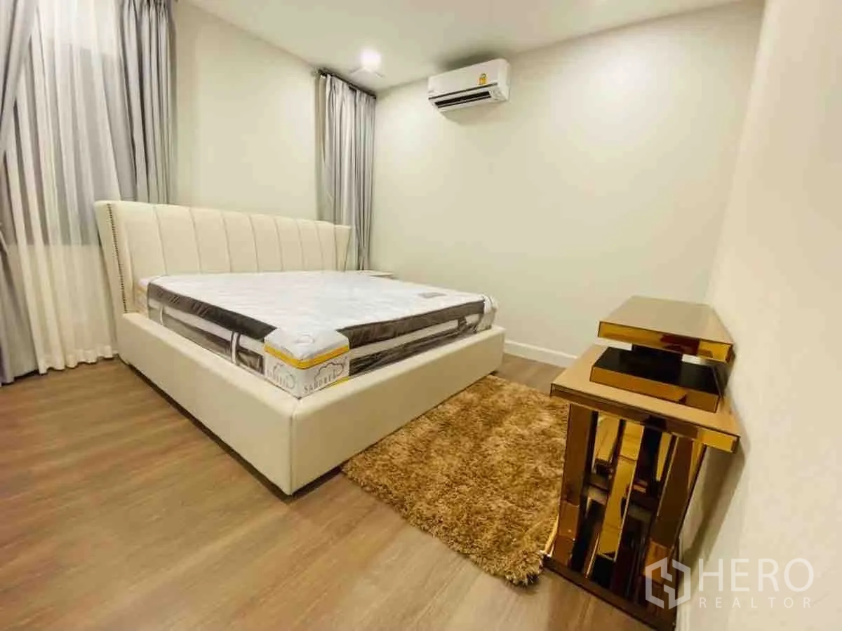 Detached House for rent or sale in Saphan Sung, Bangkok - Guest bedroom angle showing padded headboard and air conditioner