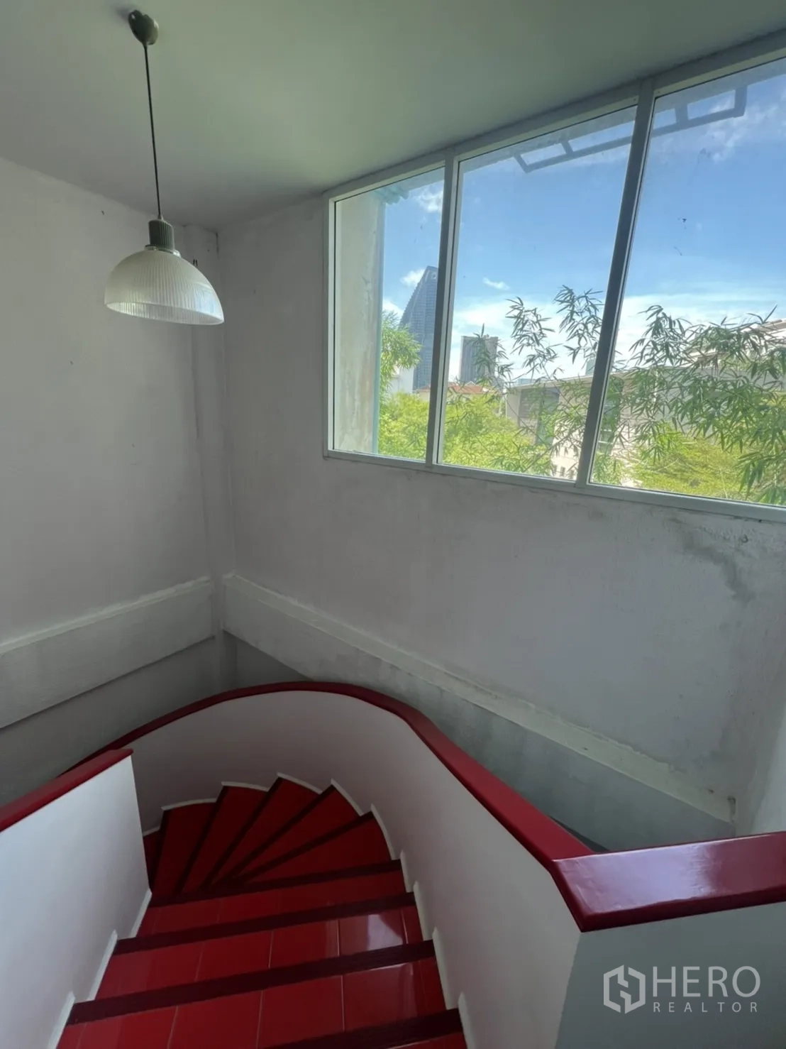 อาคารพาณิชย์ ให้เช่าในKhlong Toei, Bangkok - บันไดพร้อมหน้าต่างรับแสง เห็นวิวต้นไม้และเส้นขอบฟ้าเมือง