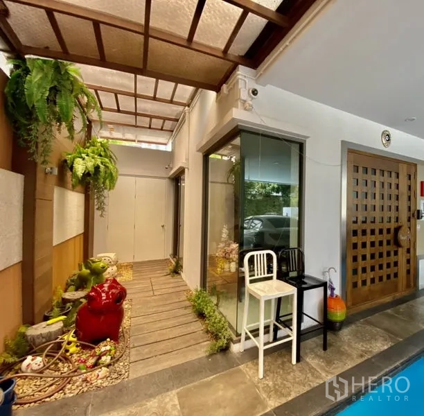 Home Office for rent or sale in Yan Nawa, Bangkok - Covered entry corridor with skylight roof, wood walkway, and small garden beside a glass corner.