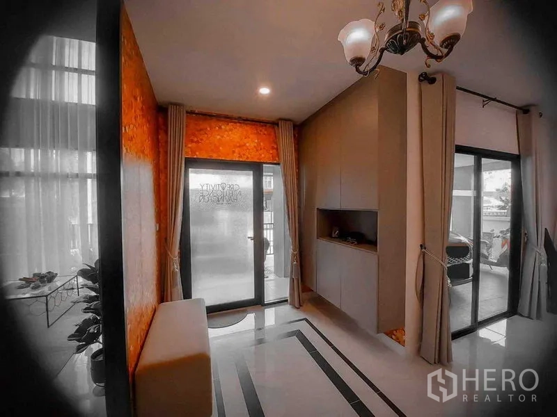 Detached House for rent in Bang Bo, Samut Prakan - Entry foyer with chandelier, built-in cabinets and sliding glass doors.