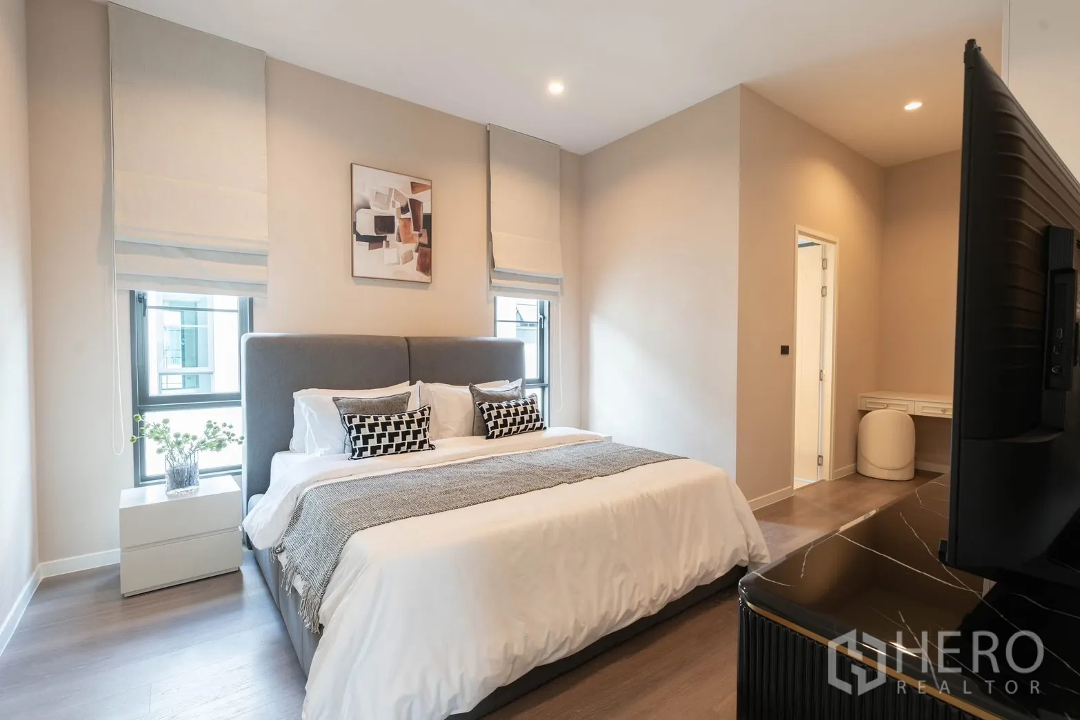 Detached House for rent in Bang Phli, Samut Prakan - Modern bedroom with gray headboard, bedside tables, and ensuite access.