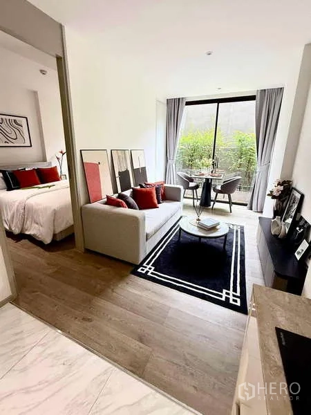Condominium for rent - Open-plan living and dining area with sliding door to the bedroom and a large window.