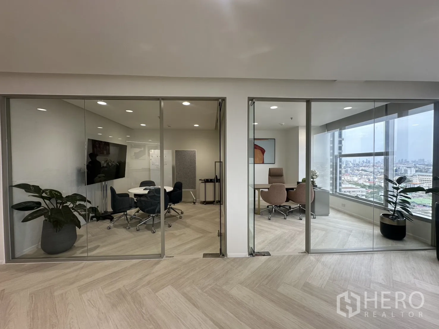 Office Space for rent in Sathon, Bangkok - Glass-partitioned corridor revealing a meeting room and executive office with skyline outlooks.