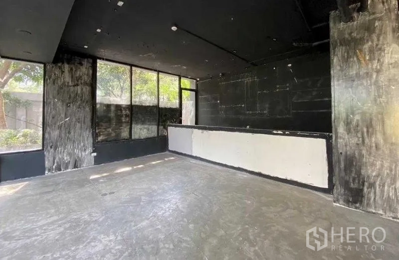 零售空间 出租在Khlong Toei, Bangkok - 转角区域，大片窗户与服务吧台，外望绿化。