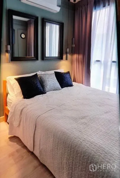Condominium for rent in Phra Khanong, Bangkok - Master bedroom with large windows, mirrors and soft bedding.