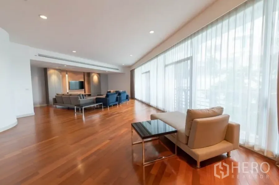 Condominium for rent - Expansive living room with floor-to-ceiling windows, hardwood floors and modern sofas.