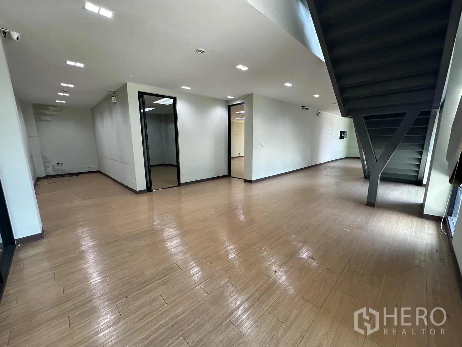 Home Office for rent in Prawet, Bangkok - Spacious ground-floor office area with internal rooms and a steel staircase.