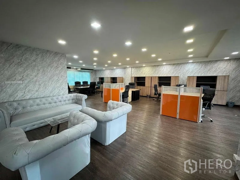 Home Office for rent or sale in Bang Phli, Samut Prakan - Open‑plan office level with workstations, tufted sofas and a marble feature wall.