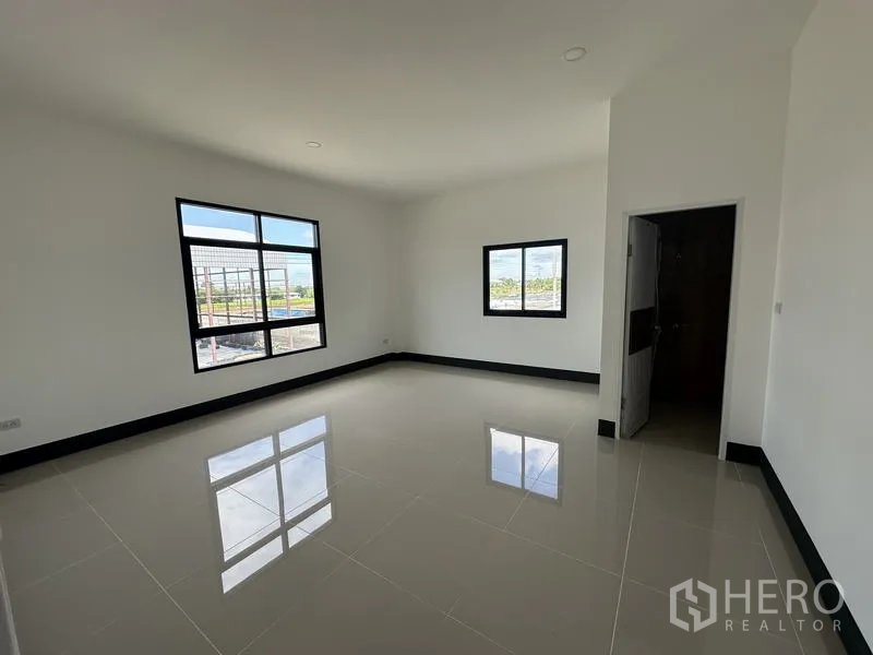 工厂 出租或出售在Sai Noi, Nonthaburi - 干净的瓷砖卫生间，设有窗户、洗手盆与坐便。