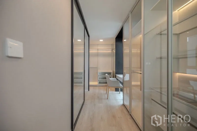Detached House for rent in Saphan Sung, Bangkok - Walk-in closet corridor with glass wardrobes and dressing table.
