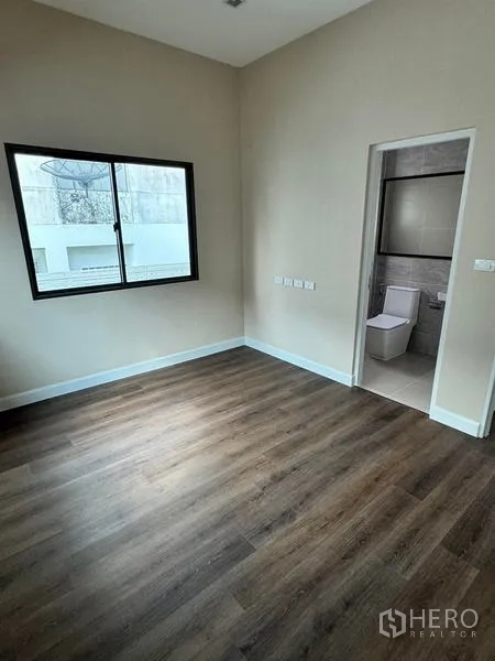 Detached House for rent or sale - Bedroom with window and ensuite bathroom, dark wood flooring.
