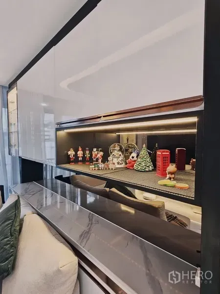 Condominium for sale in Bang Rak, Bangkok - Close-up of illuminated display shelf and marble ledge in the living area.