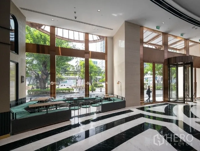 Retail Space for rent in Bang Rak, Bangkok - Double-height lobby area with black-and-white marble flooring and built-in seating.