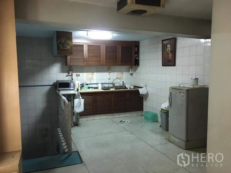 อาคารพาณิชย์ ให้เช่าในPhra Khanong, Bangkok - ครัวปูกระเบื้องพร้อมตู้ไม้ ซิงก์ ไมโครเวฟ และตู้เย็น